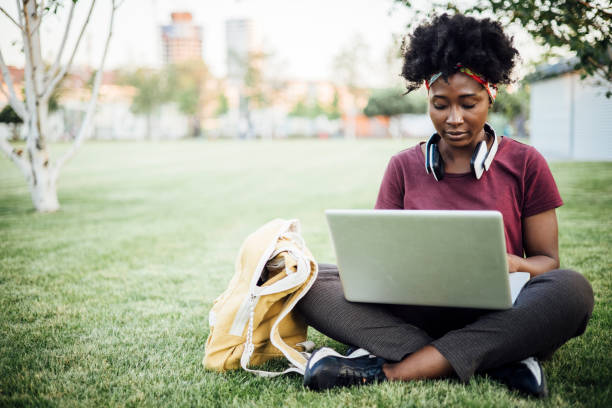istock African American student enjoying in the park and studying 1325257176