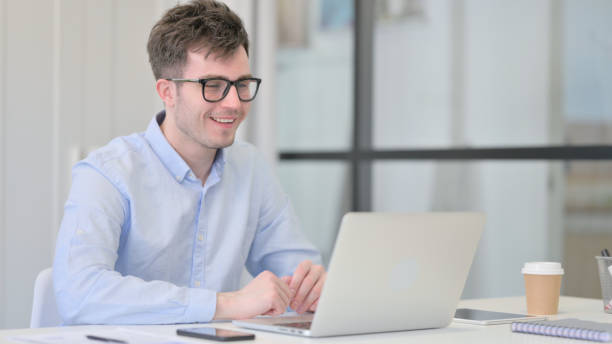 istock Young Man Talking on Video Call on Laptop 1325258124