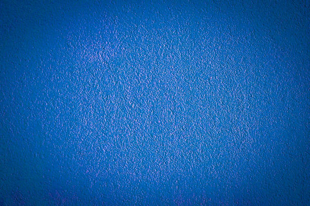 istock Blue painted wall with vignetted knots.  Old colored stone wall texture. 1325258229