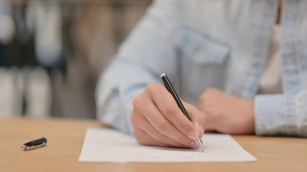 istock Male Hands Writing on Paper, Close up 1325258439