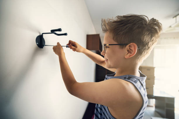istock Little boy removing the guitar wall mount 1325258471