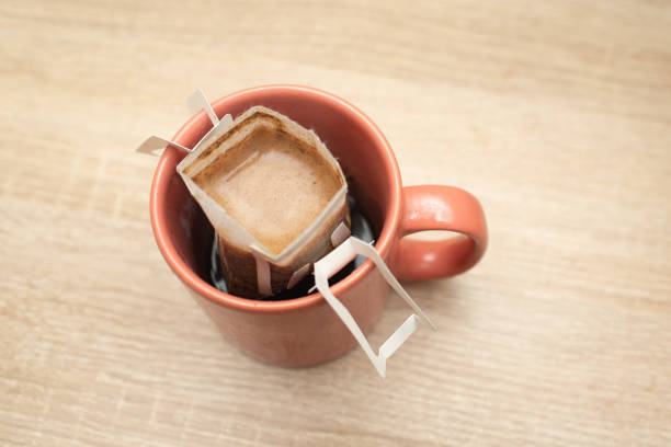 istock Coffee Drips in cup. Alternative brewing coffee in paper filter bags. 1325259778