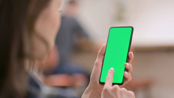 istock Female Holding Smartphone with Green Chroma Key Screen 1325259868