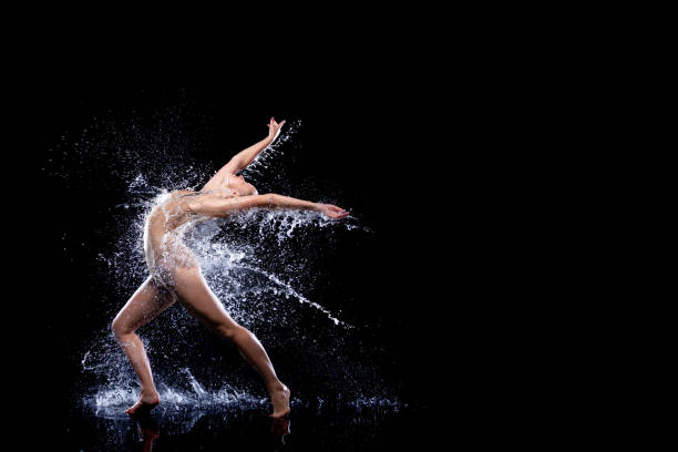 istock Woman dancer is doing modern art dance in water 1325260517