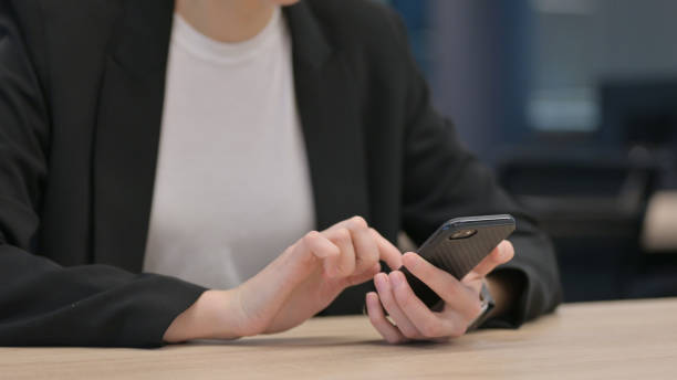 istock Close up of Female Hands Using Smartphone 1325261264