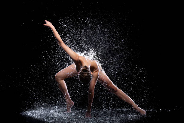 istock Woman dancer is doing modern art dance in water 1325262304