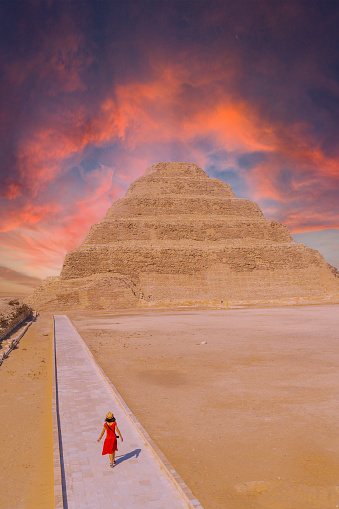 A young woman visiting the Stepped Pyramid of Djoser, Saqqara. Egypt. The most important necropolis in Memphis. The first pyramid in the world