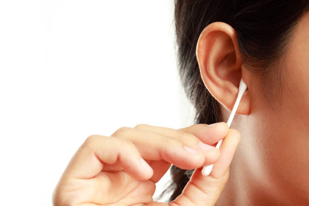 istock Woman is cleaning her ears with cotton buds 1325263684
