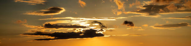 istock The sun shines through the clouds at sunset 1325264629
