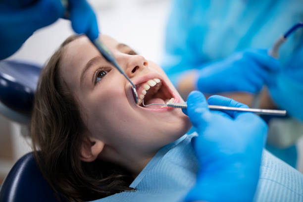 istock Dentist doing dental examination on child patient. 1325265411