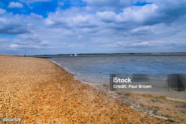 Calshot Beach At Low Tide Stock Photo - Download Image Now - Beach, Beach Holiday, Blue