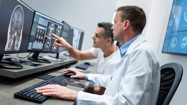 istock Colleagues discussing MRI scan displayed on computer monitor. 1325269167