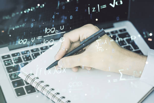 istock Creative scientific formula illustration with hand writing in diary on background with laptop, science and research concept. Multiexposure 1325269347