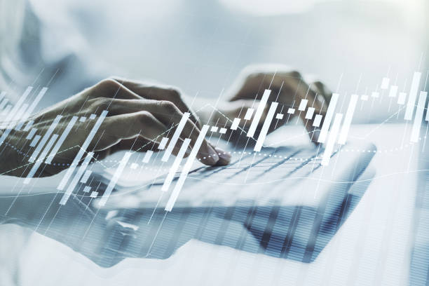 istock Abstract creative financial graph with hand typing on laptop on background, financial and trading concept. Multiexposure 1325269358