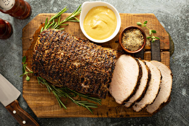 Roasted pork loin with a spice rub and mustard Roasted pork loin with a spicy rub and mustard sauce loin stock pictures, royalty-free photos & images