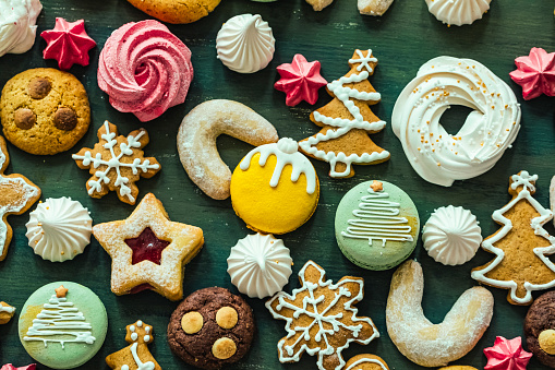 Christmas cookies in the shape of a Christmas tree, a snowman and a gingerbread man on on the table. Close-up. Selective focus.