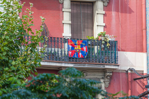 View of a balcony with cast iron railing and Barca flag attached to it during daytime