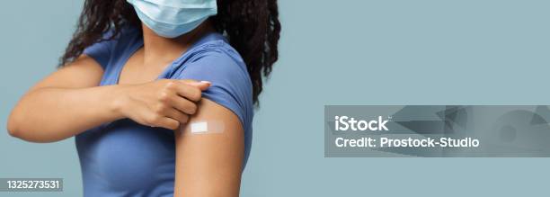Antiviral Vaccination African American Woman Showing Plaster On Shoulder After Covid19 Vaccine Injection Panorama Stock Photo - Download Image Now