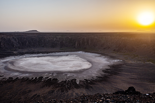 Sunrise at the Al Wahbah Crater in the lava fields of Harrat Kishb. Salt (Sodium phosphate) crystals are at the bottom of the crater.