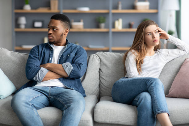 istock Relationship Crisis. Offended Interracial Couple Sitting On Couch After Quarrel 1325274933