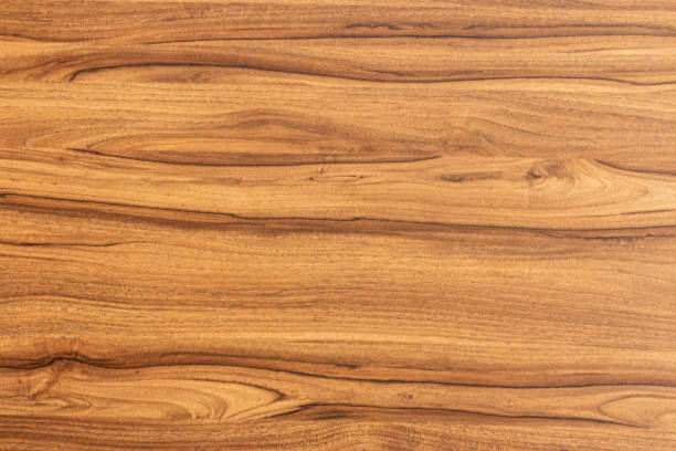 Close up of a walnut wood veneer Natural varnished wood texture background. Top view of an walnut wood veneer Background of walnut wood. Top view of a wood sample surface. walnut wood photos stock pictures, royalty-free photos & images