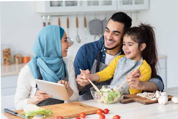 istock Happy Islamic Family Checking Recipe On Digital Tablet While Cooking In Kitchen 1325275009