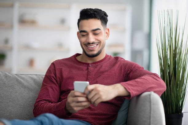 istock Happy arab man enjoying new mobile application 1325275642