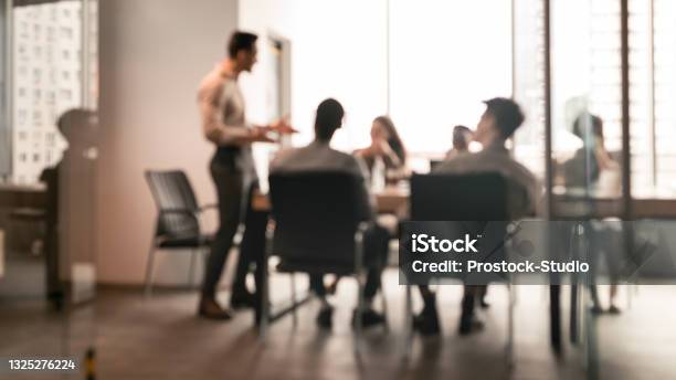 Colleagues Having Meeting In Boardroom Businessman Giving Speech Blurred Photo Stock Photo - Download Image Now