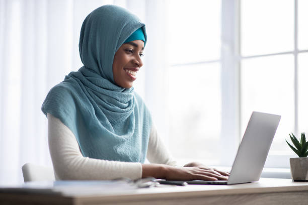 istock Remote Work. Happy Black Muslim Freelancer Lady In Headscarf Using Laptop Computer 1325276310