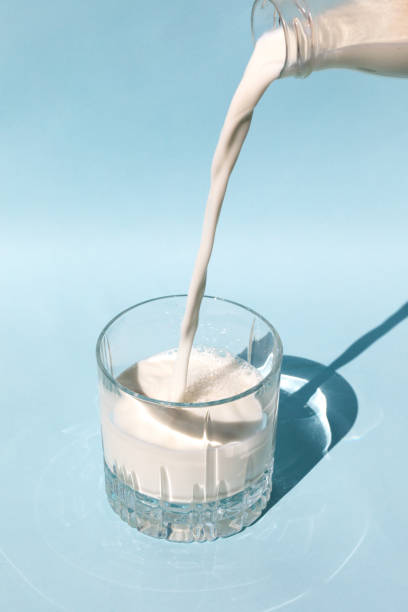 istock milk pours into the glass 1325276407
