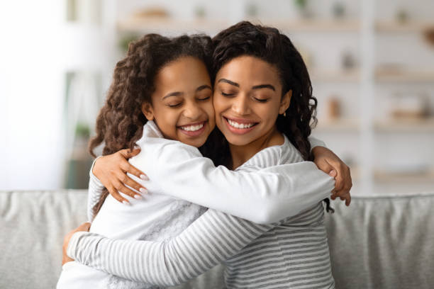 istock Beautiful black lady hugging her cute little daughter 1325278001