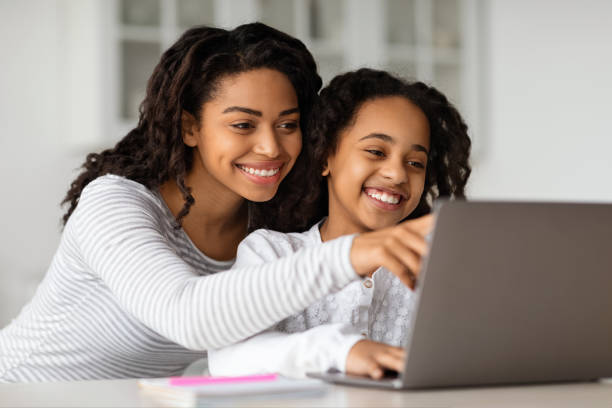 istock Pretty african american mom helping her studying kid, copy space 1325278520