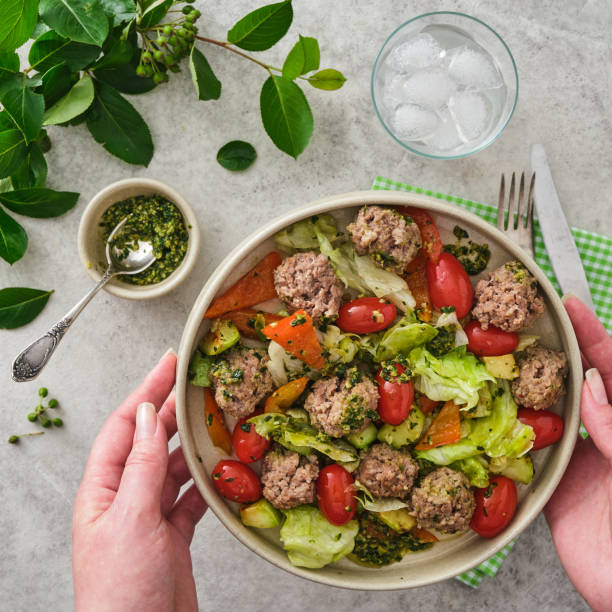 istock Meatballs with cherry tomatoes and salad. 1325279891
