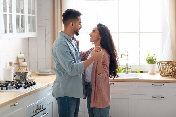 istock Portrait Of Happy Affectionate Arab Spouses Bonding Together In Kitchen 1325279898