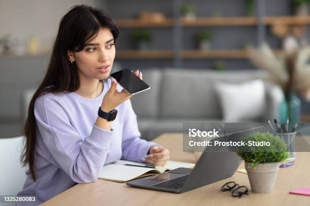 Woman Using Voice Search Assistant On Smart Phone Stock Photo - Download Image Now - Filming, Voicemail, Telephone