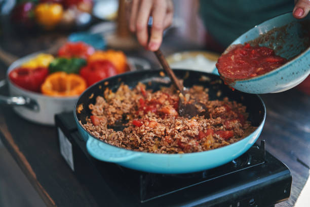istock Preparing Stuffed Bell Peppers with Ground Meat in Tomato Sauce 1325280813