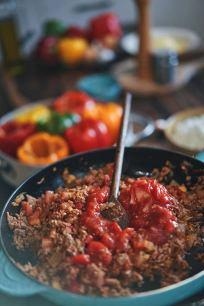 istock Preparing Stuffed Bell Peppers with Ground Meat in Tomato Sauce 1325281058