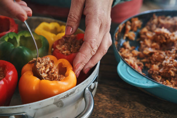istock Preparing Stuffed Bell Peppers with Ground Meat in Tomato Sauce 1325281133