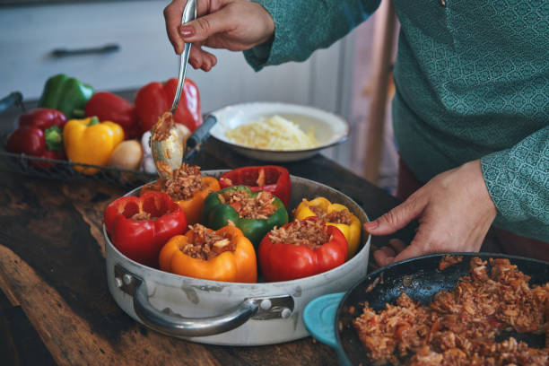 istock Preparing Stuffed Bell Peppers with Ground Meat in Tomato Sauce 1325281844
