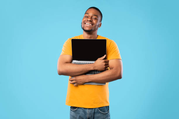 istock African American Man Hugging Laptop With Empty Screen, Blue Background 1325281883
