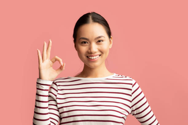 istock It's Ok. Cheerful Young Asian Lady Showing Okay Gesture At Camera 1325281914