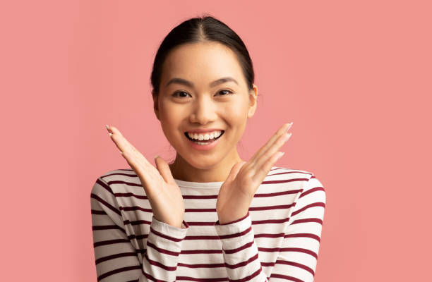 istock Surprised Young Korean Lady Raising Hands And Looking At Camera With Excitement 1325281949