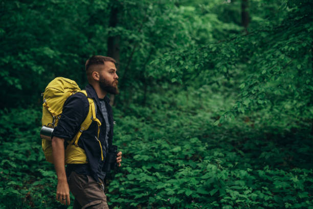 istock Hiker man walking in the nature while wearing backpack and enjoying nature 1325281967