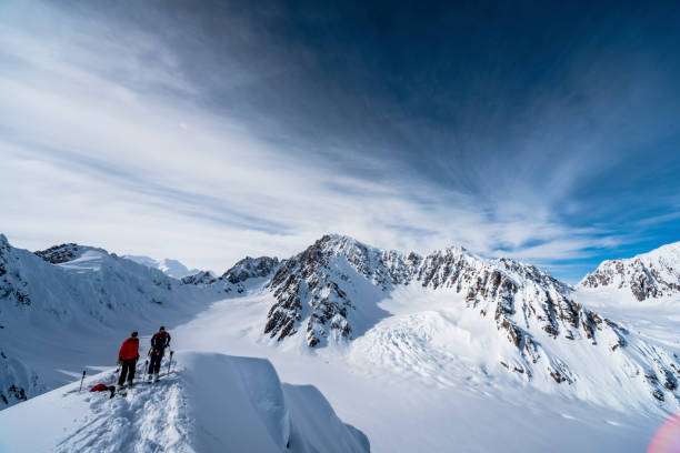 istock Backcountry skiers relax on snowy mountain ridge 1325283268