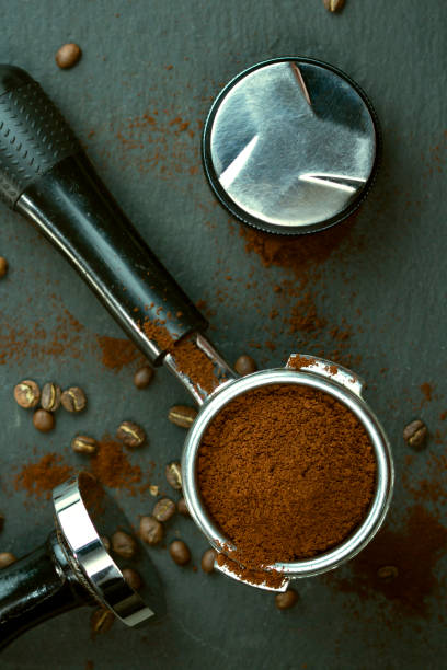 istock Portafilter with coffee bean and temper on concrete table 1325286526