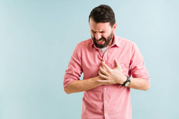 Sick man suffering from coronary issues Hispanic man in his 30s having a heart attack and suffering from chest pain. Middle age man with a cardiovascular disease coronary artery photos stock pictures, royalty-free photos & images