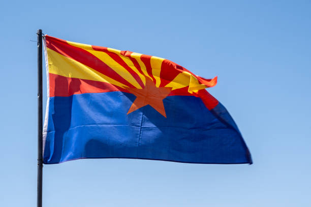 istock Arizona State flag, waving in the wind against blue sky 1325289937