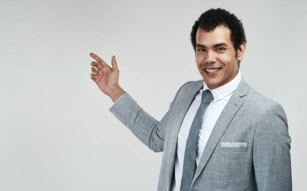 istock Studio shot of a businessman pointing at copyspace against a grey background 1325290202