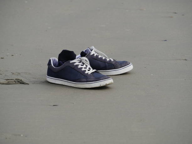 istock Sneaker shoes on the beach 1325291124