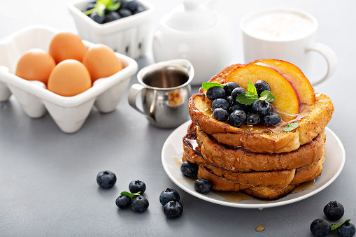 French toasts with fresh blueberry and peach for breakfast